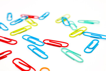 Colorful Paper Clips Scattered on White Background - Office Supplies Still Life