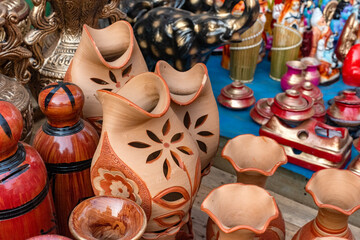 Assortment of handcrafted terracotta vases and pottery on display. Different pottery products in a...