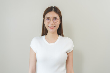 Obraz premium Portrait of beautiful asian young woman happy wearing glasses and smiling, cute girl with new eyeglasses sitting relaxed with copy space isolated on background. Health care of optical people concept.