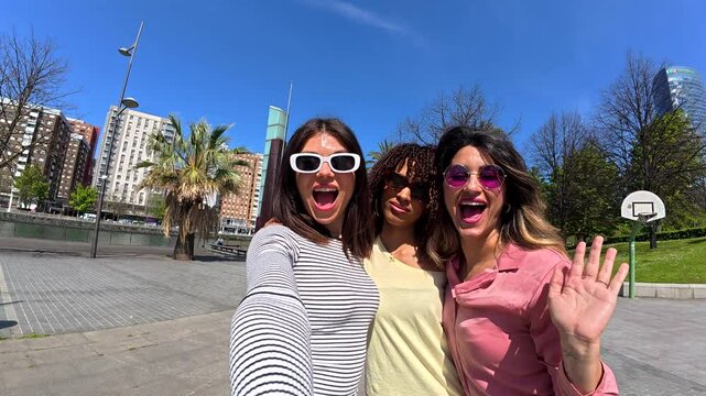 Cheerful friends taking a selfie in bilbao city center
