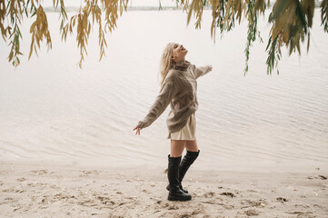 Beautiful young blonde pouting, flirting, duck lips. Portrait in hat autumn inspiration freedom