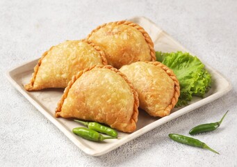 Pastel Goreng in Indonesia, pastel refers to a type of kue filled with meat, vegetables, and rice vermicelli deep fried in vegetable oil. It is consumed as a snack and commonly sold in Indonesian trad