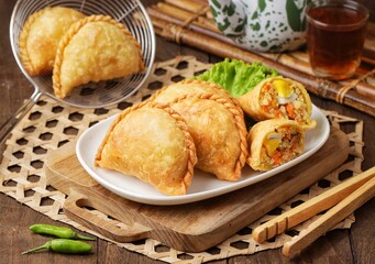 Pastel Goreng in Indonesia, pastel refers to a type of kue filled with meat, vegetables, and rice vermicelli deep fried in vegetable oil. It is consumed as a snack and commonly sold in Indonesian trad