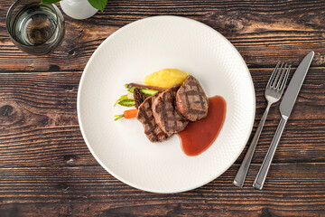 Juicy grilled filet medallions served with seasonal vegetables and sauce