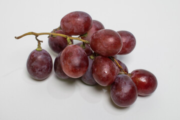 Shiny, plump red grapes with natural bloom, ideal for fruit lovers.