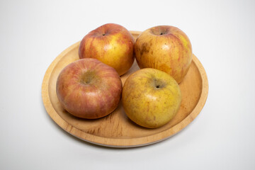 Fresh and simple apples on a round wooden plate.