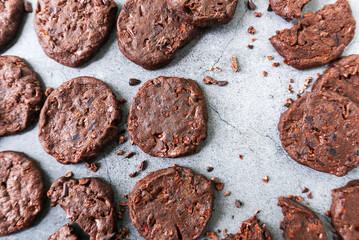 cacao nibs chocolate chunk cookies on grey background.
