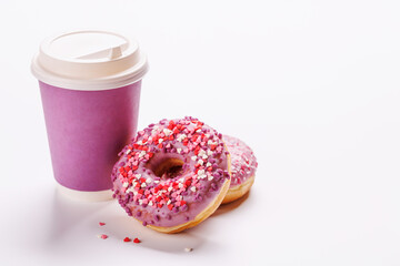 A cheerful display of donuts and a paper coffee cup on a white background
