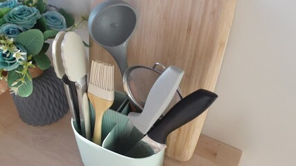Kitchen tools organized in utensil holder on countertop