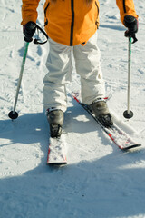 Excitement fills the air as a skier prepares for an exhilarating descent on a sunlit mountain slope...