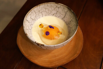 Close up bowl of Thai twist jelly dessert served with coconut custard milk decorated in modern...