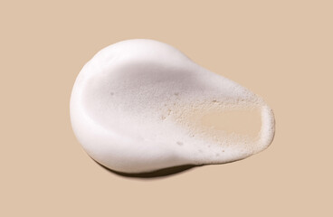 texture foam mousse foam cosmetic smear sample on beige background