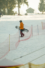 Snowboarder navigating the slope with determination on a sunny winter day surrounded by beautiful...