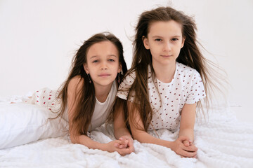 Pajama party. Happy children's laughter. Happy girls laughing, lying next to each other. Concept of...