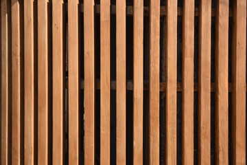 wall of sunlit wooden slats