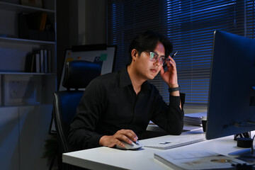 businessman working in the office in the late night during overtime period. Deadline concept.and...
