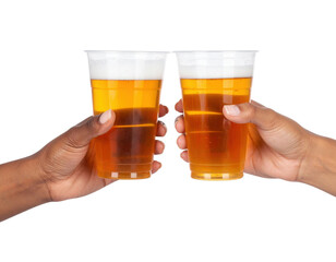 Two hands holding plastic cups filled with amber-colored beer, raised as if toasting.