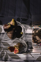 Juicy figs in a ceramic bowl on a wooden table - still life with natural light