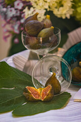 Juicy figs in a ceramic bowl on a wooden table - still life with natural light
