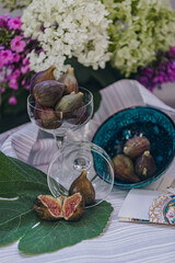 Juicy figs in a ceramic bowl on a wooden table - still life with natural light
