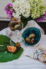 Juicy figs in a ceramic bowl on a wooden table - still life with natural light