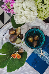 Juicy figs in a ceramic bowl on a wooden table - still life with natural light