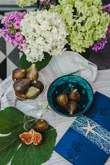 Juicy figs in a ceramic bowl on a wooden table - still life with natural light