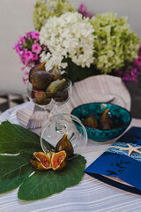 Juicy figs in a ceramic bowl on a wooden table - still life with natural light
