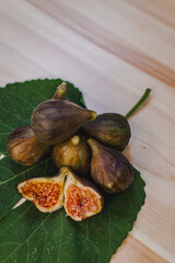 Juicy figs in a ceramic bowl on a wooden table - still life with natural light