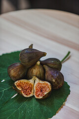 Juicy figs in a ceramic bowl on a wooden table - still life with natural light