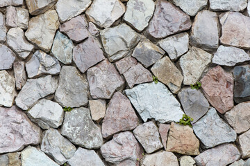 A wall made of gray and white stones