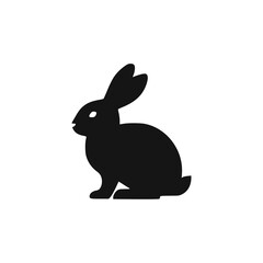 Fototapeta premium Silhouette of a black rabbit facing left against a white background.