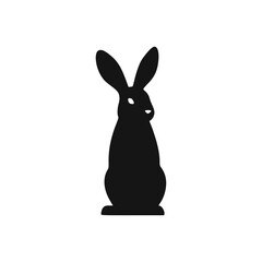 Fototapeta premium Silhouette of a rabbit standing upright, facing forward with long ears.