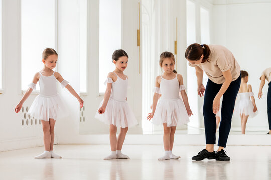 little ballerinas learn to get into first position with a teacher