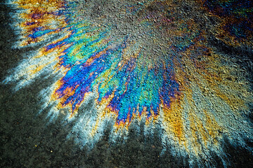 Oil stain on Asphalt road after rain, color Gasoline fuel spots on Asphalt Road