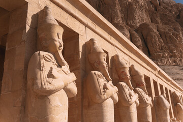Majestic statues of pharaohs guarding hatshepsut temple in luxor, egypt