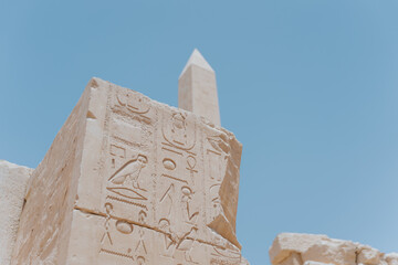 Karnak temple walls showing ancient egyptian hieroglyphs and obelisk