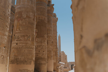 Karnak temple columns showing ancient egyptian hieroglyphs and obelisk