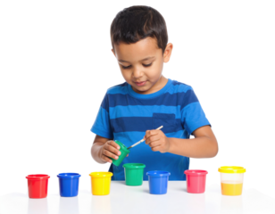 A young boy in a blue striped shirt is painting with colorful paint pots, concentrating on his creative activity.
