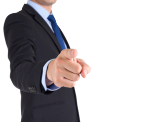 A man wearing a black suit, blue tie, and light blue shirt is pointing directly forward with his right hand.