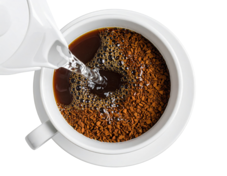 Hot water is being poured into a white cup filled with instant coffee granules, starting the brewing process.