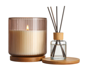 A lit cream-colored candle in a ribbed glass holder sits next to a reed diffuser with wooden sticks in a clear liquid, both placed on round wooden bases.
