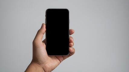 Hand holding modern smartphone with blank screen for mockup or design