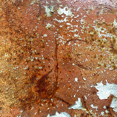 Close-up texture of corroded rusty metal with peeling paint and oxidized surface details in square format for industrial background use