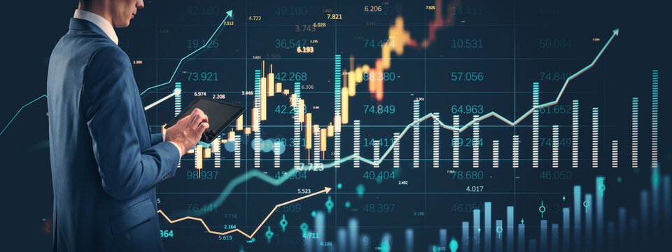 Businessman analyzing financial market data on tablet with digital stock charts and growth indicators in virtual interface overlay background.
