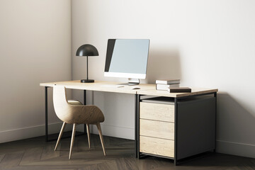 Modern wooden desk setup in cozy home office corner with blank computer screen, books, lamp, and armchair on parquet floor background. 3D Rendering