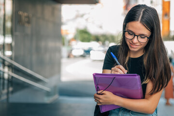 Teenage girl finishes up homework before school