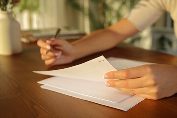 Woman hands reading document at home
