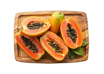 Exotic ripe papaya fruit halved showing seeds on wooden cutting board