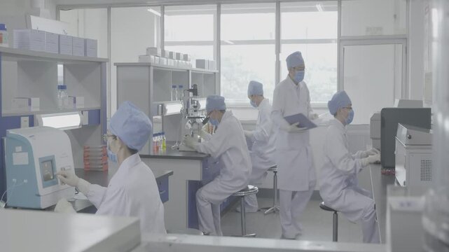 Scientists wearing clean lab coats work meticulously in a well-illuminated, sterile laboratory, focusing on pathogen research and disease analysis, highlighting collaboration in microbiology. - Powered by Adobe